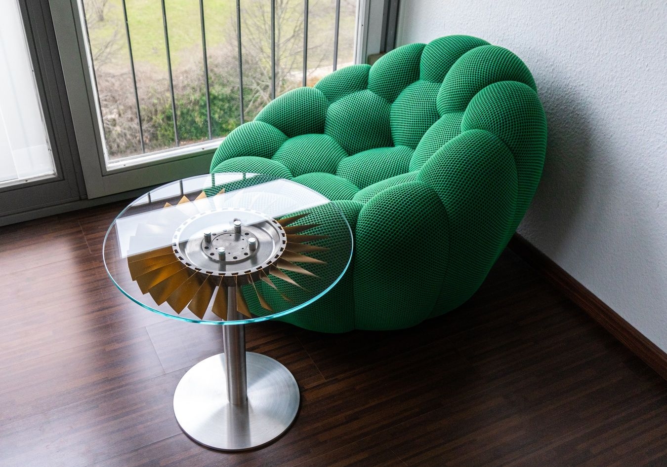 The final Turbine Table conveniently placed next to a designer chair making both of these items look great.
Three Turbine Tables were made. Two with golden fan blades and one with silver fan blades. Two are for sale.